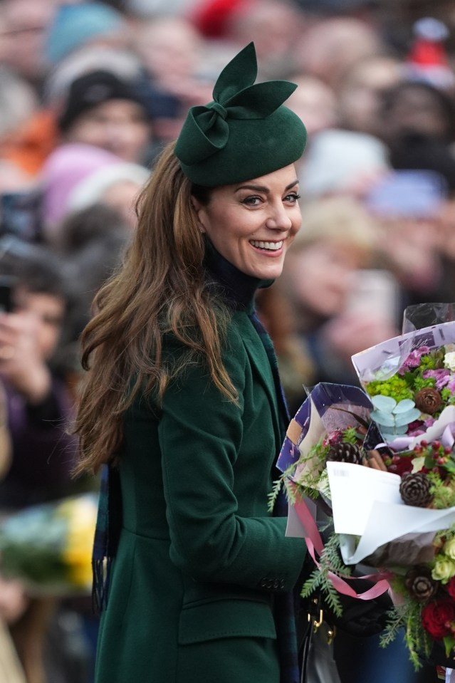 The Princess of Wales smiles and accepts flowers from members of the public after a Christmas Day church service.