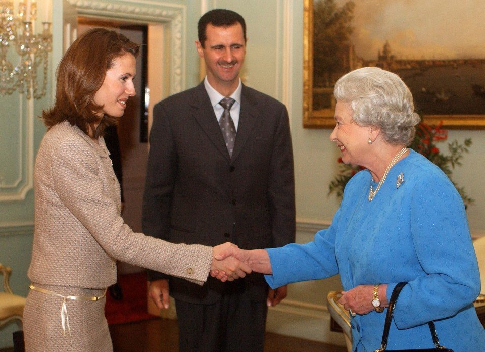 Queen Elizabeth II shakes hands with Asma Al-Assad and Bashar Al-Assad at Buckingham Palace.