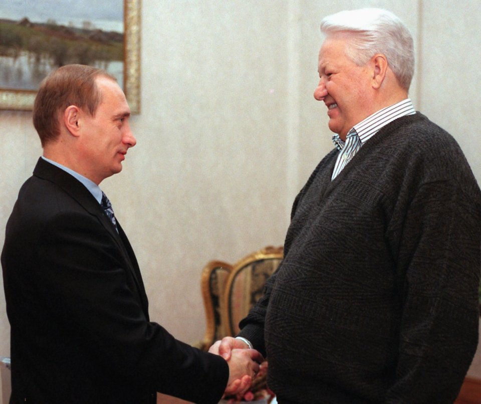 The future tyrant shaking hands with predecessor Boris Yeltsin