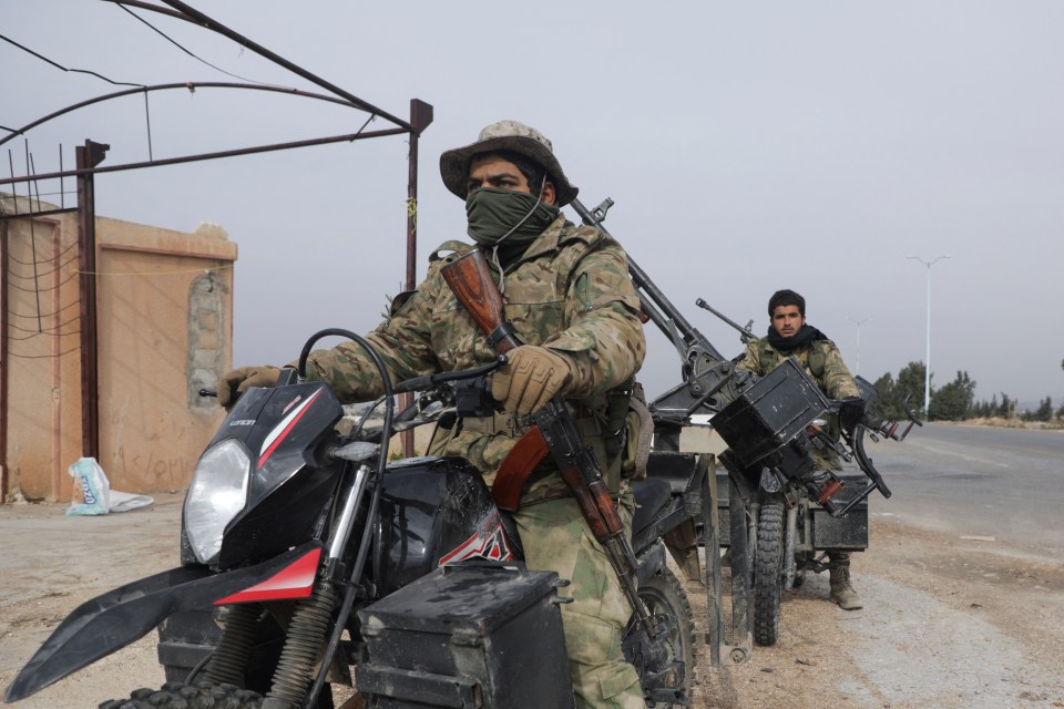 Rebel fighters on motorcycles in Homs