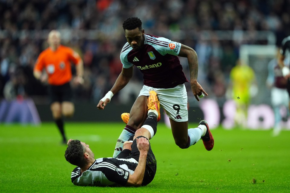 A soccer player from Aston Villa fouls a Newcastle United player, resulting in a red card.