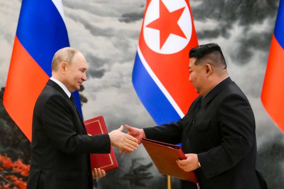 Vladimir Putin, left, and North Korea’s leader Kim Jong Un exchange documents during a signing ceremony of the new partnership in June 2024