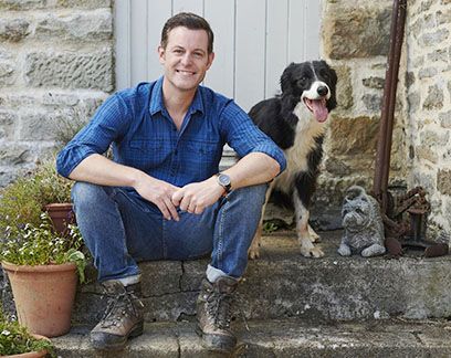 Man sitting on steps with dog.