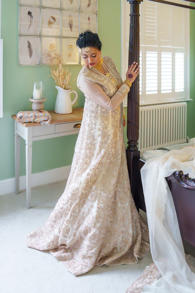 The bride wore a traditional gold and cream outfit with crystal and rose gold embroidery