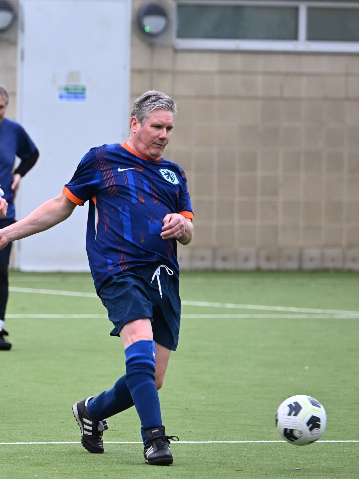 Keir Starmer playing football in a Dutch football shirt.