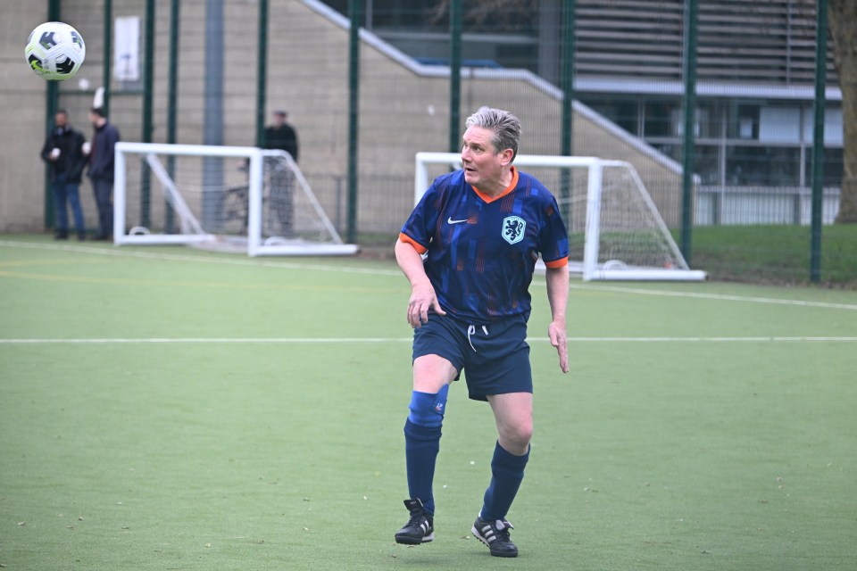 Keir Starmer playing football in a Dutch national team shirt.