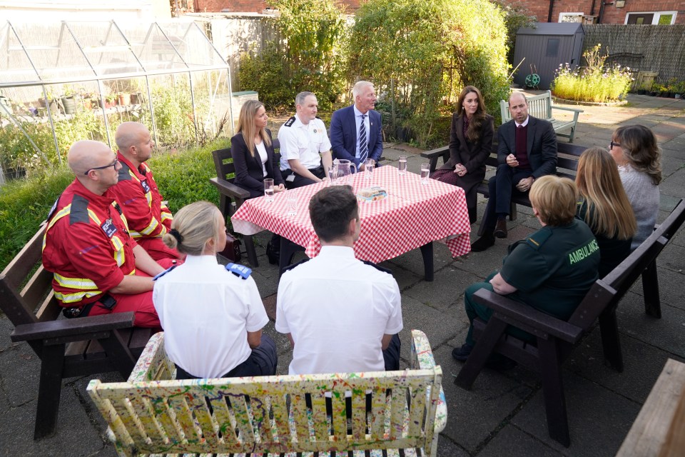 William and Kate speaking with members of the emergency services during a visit to Southport Community Centre