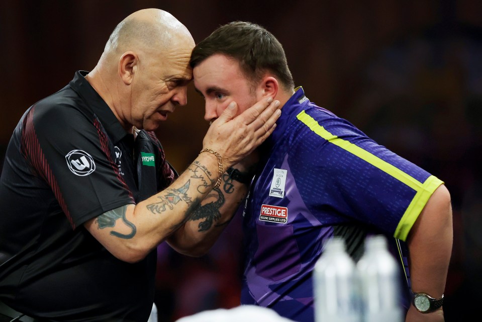 Russ Bray speaks with Luke Littler during his last match before retiring — the World Darts Championship 2024 final between Luke Littler and Luke Humphries