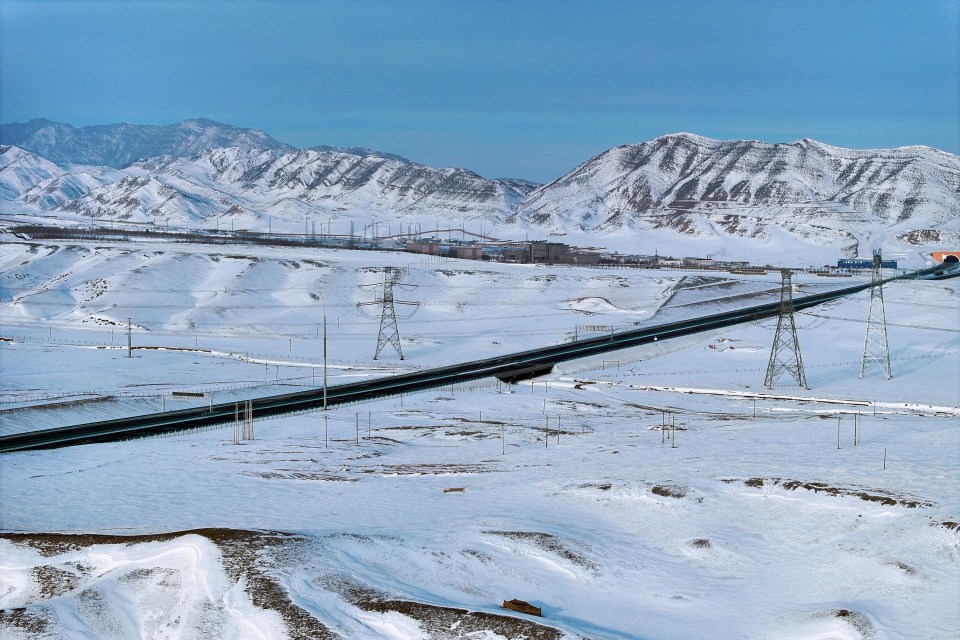 Aerial view of a snow-covered highway in Urumqi, China.