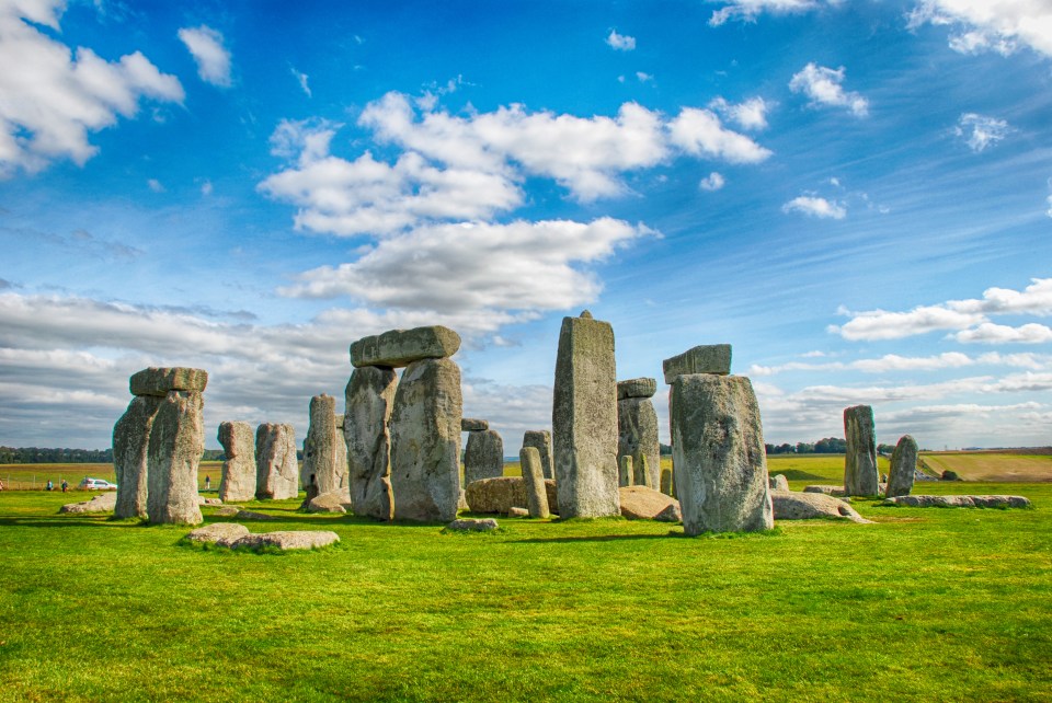 Stonehenge under a bright, cloudy sky.