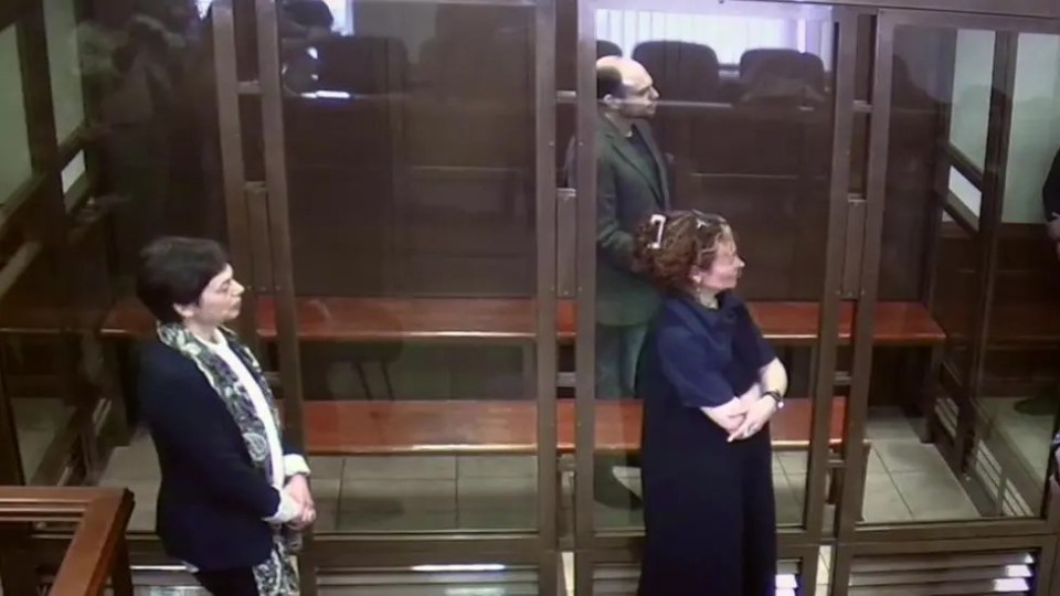 Elena (left) stood by her son's glass cage as he was sentenced to 25 years behind bars in 2023