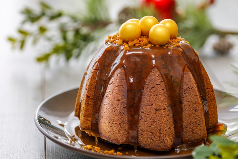 Gingerbread Christmas pudding with caramel sauce and gold chocolate balls.