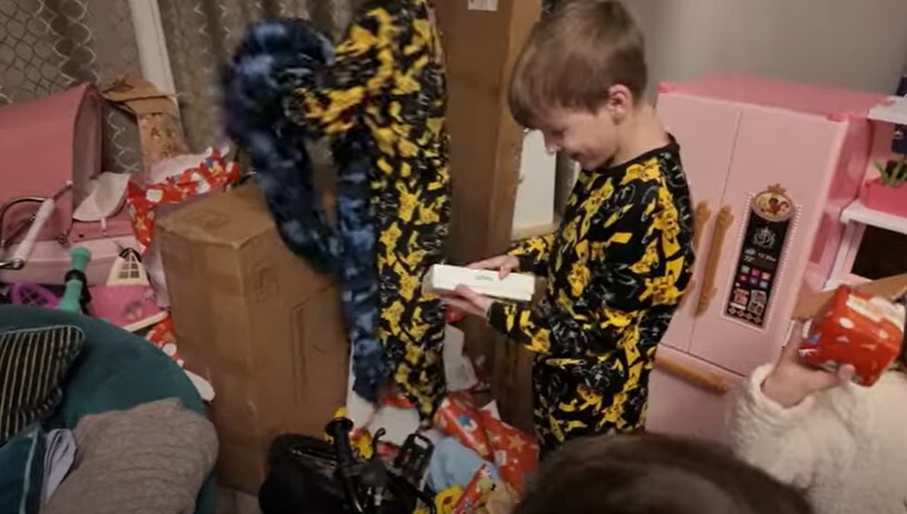 Casper, 12, looked delighted as he opened his pricey present - his first-ever iPhone