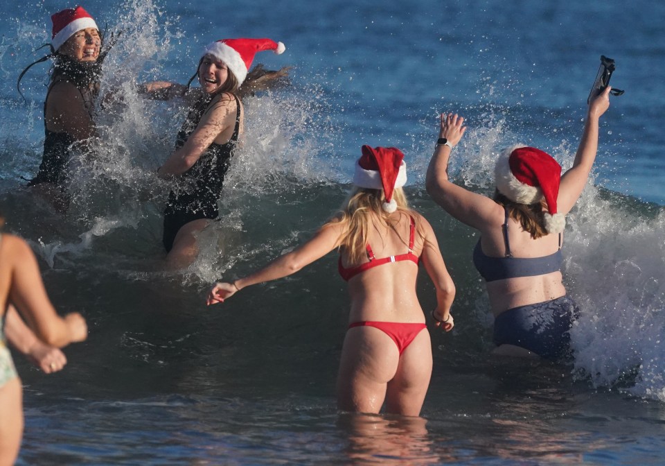 Boxing Day dippers headed out to sea this morning in bikinis and Santa hats