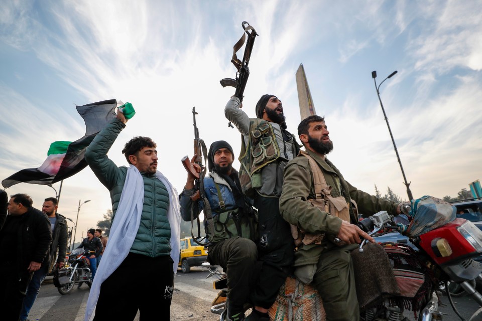 Syrian opposition fighters celebrate after the Syrian government collapsed in Damascus, Syria, on Sunday