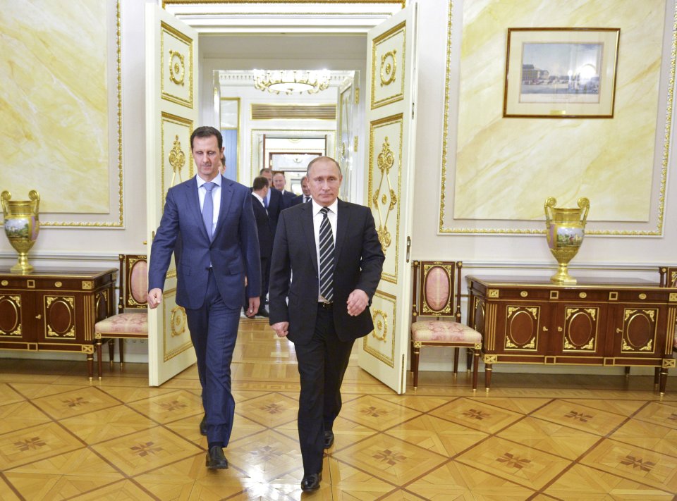 Vladimir Putin with Assad, who is now under his care in Moscow (file photo)