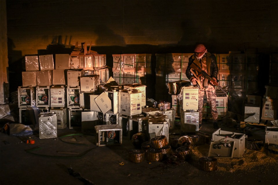 A Syrian rebel fighter stands by electrical storage components that were used to hide pills of Captagon