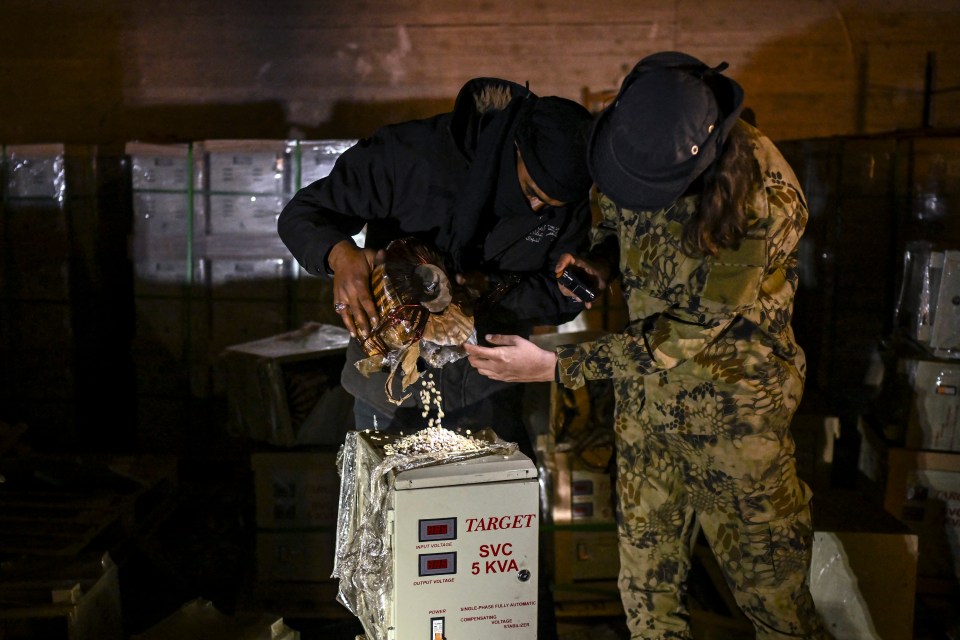 Syrian rebel fighters inspect electrical storage components that were used to hide pills of Captagon