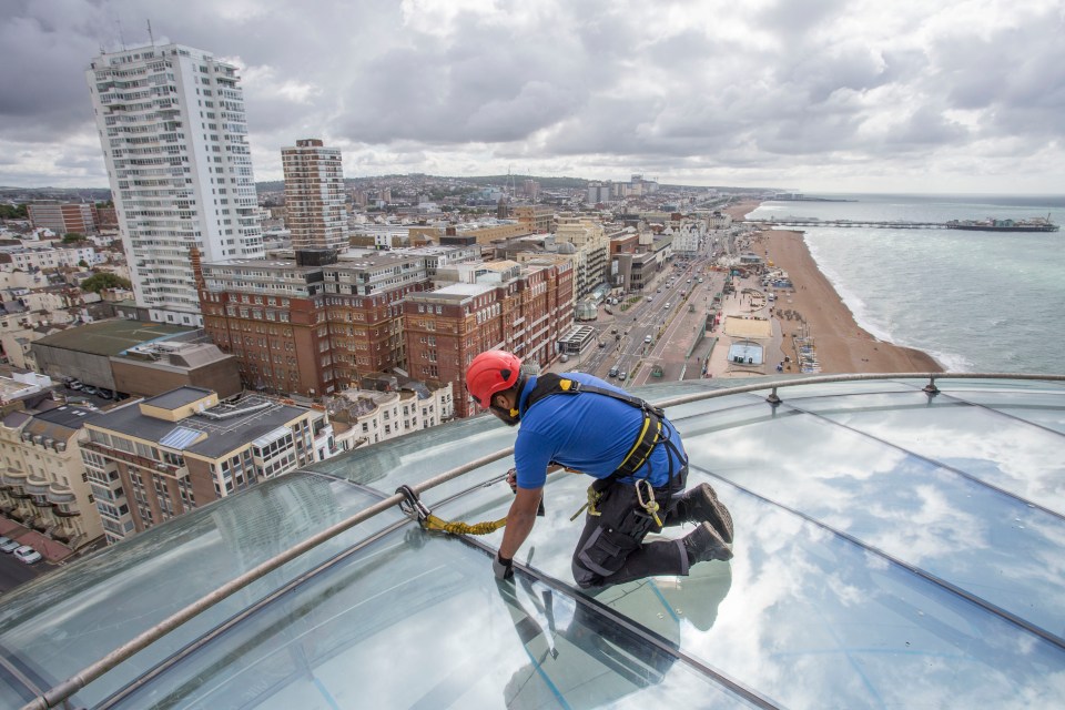 Technician Yanick Duarte checks the metal joints on top of the glass pod