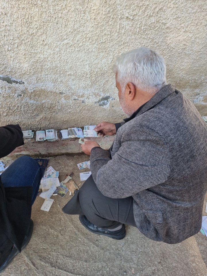 Loved ones scour through piles of ID cards to find any trace of missing relatives