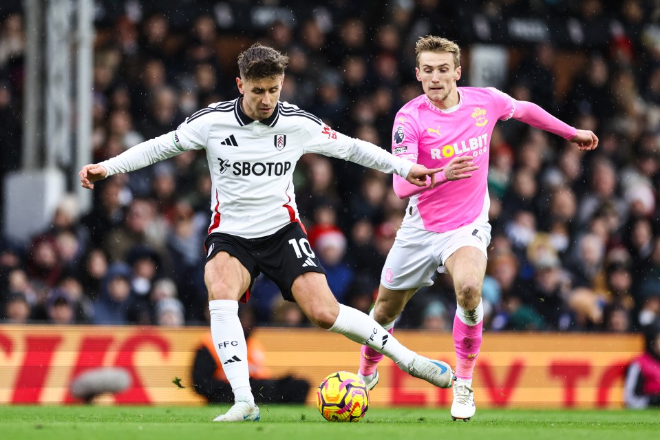 Tom Cairney of Fulham and Flynn Downes of Southampton competing for the ball during a Premier League match.