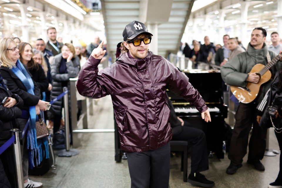 Tom Grennan performing "It Can't Be Christmas" at St. Pancras International Station.