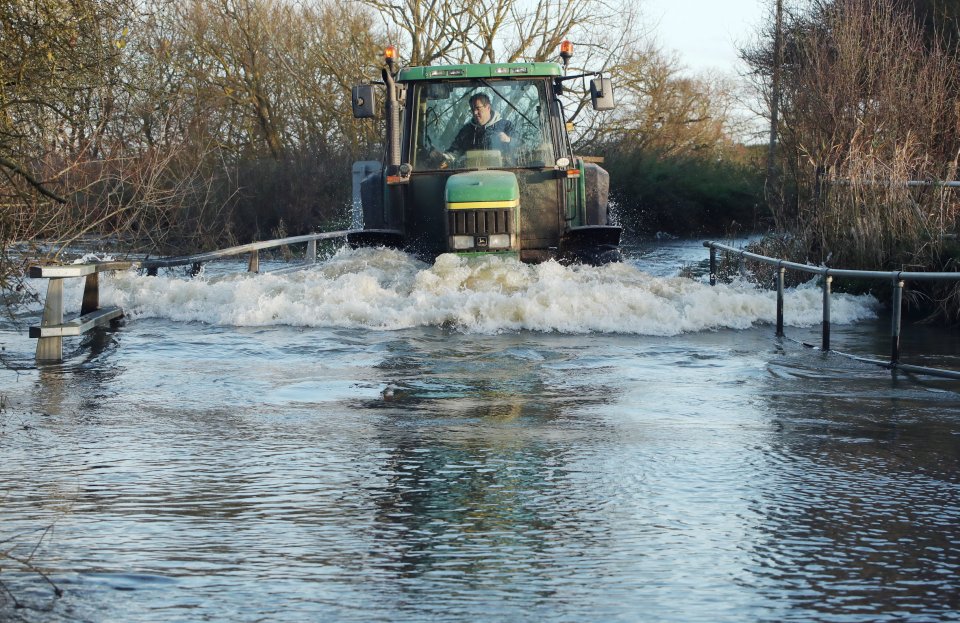 A tractor makes its way through a flooded road near Ingatestone, Essex