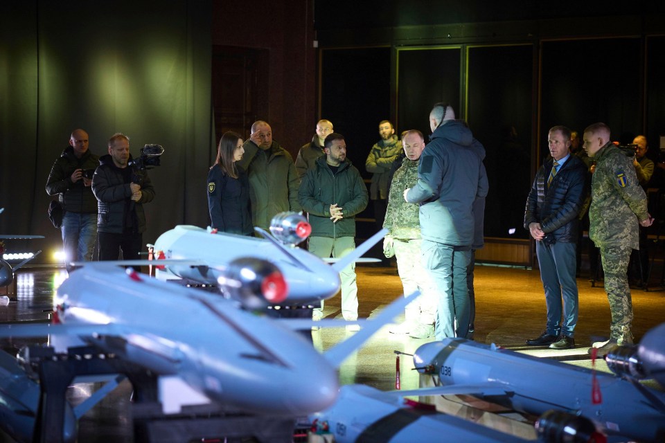 Ukrainian President Zelenskyy with defense officials at the unveiling of domestically produced long-range drones.