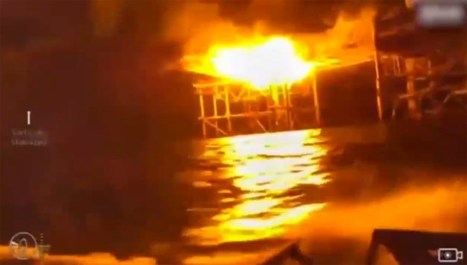 One rig is engulfed in flames after being hit by a drone