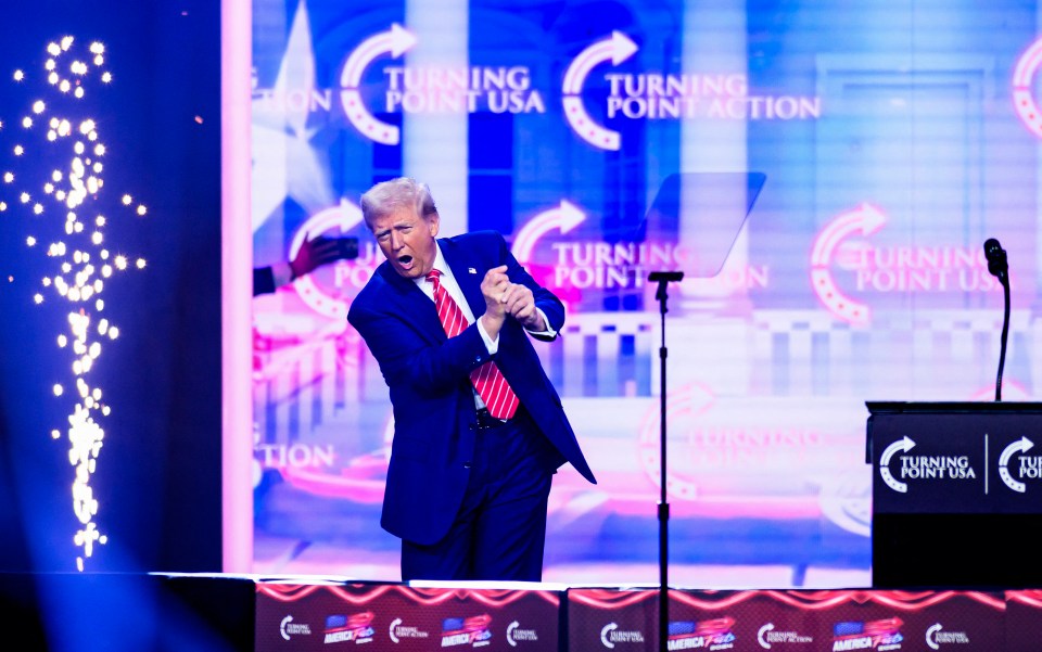 Donald Trump mimicking a golf swing at Turning Point USA's AmericaFest.