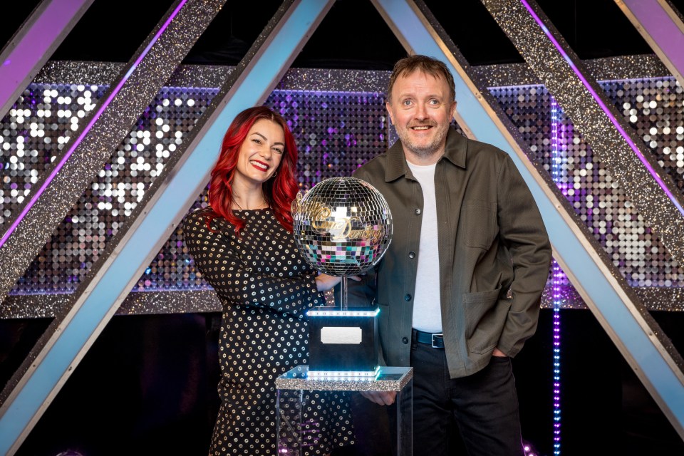 Chris McCausland and Dianne Buswell, winners of Strictly Come Dancing 2024, holding the glitterball trophy.