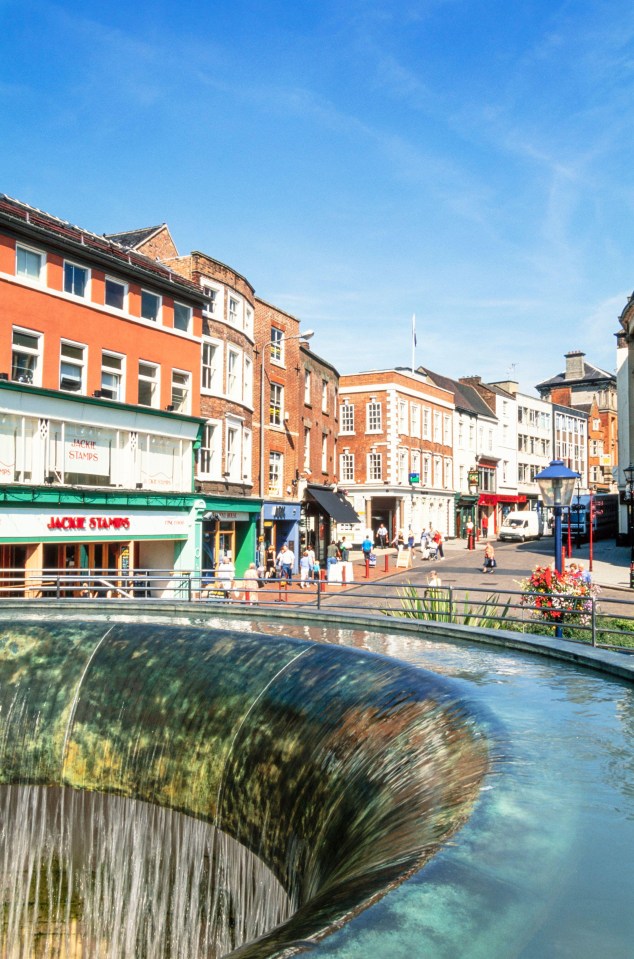 View of Derby city center shops and Jackie Stamps bar from a fountain.