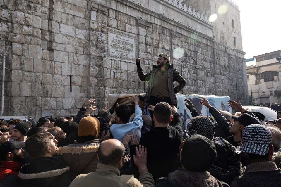 Visitors gather at the nearby Umayyad Mosque