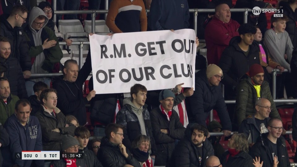 Fans hold a banner that reads "R.M. GET OUT OF OUR CLUB".