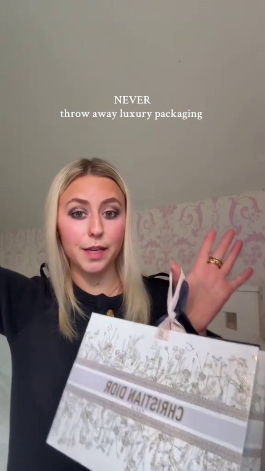 Woman holding Christian Dior gift bag; text overlay: Never throw away luxury packaging.