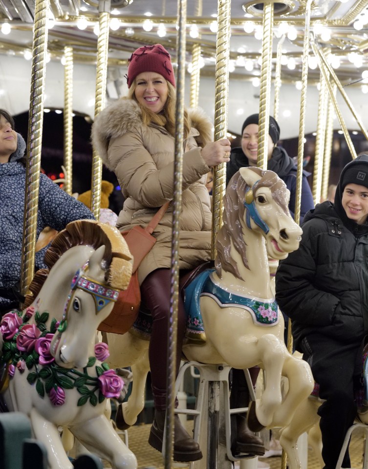 Kate Garraway enjoys a ride on the carousel during a family day out at Winter Wonderland