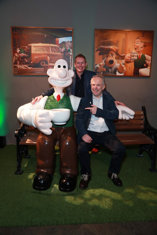 Wallace and Gromit creators Nick Park and Merlin Crossingham with a Wallace statue.