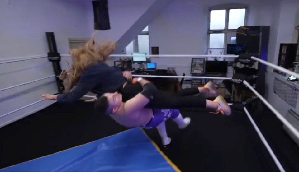 The TV presenter jumped atop a pro wrestler mid-way through her report