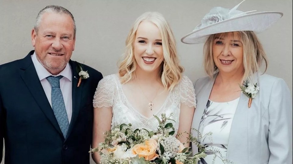 Abbie Humphries is pictured on her wedding day with parents Karen and Roger