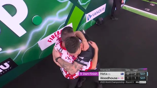 Woodhouse congratulated Heta after the nine-dart finish