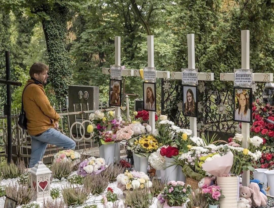 Yaroslav Bazylevych by the graves of his wife Evgeniya and the couple’s daughters Yarina, Daria and Emilia