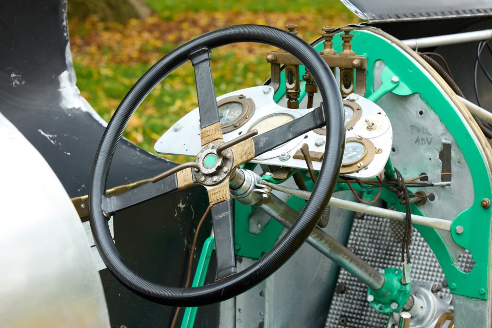 Close-up of a 1923 Aston Martin Razor Blade's steering wheel and dashboard.