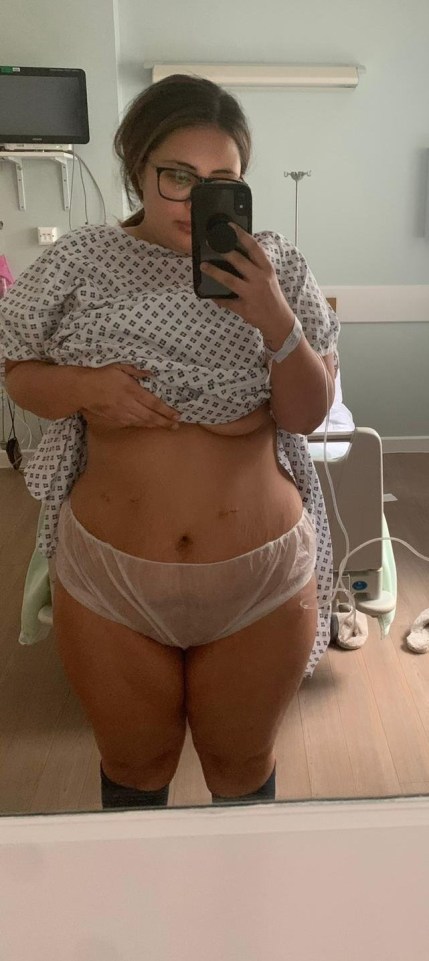 Woman in hospital gown after weight loss surgery.