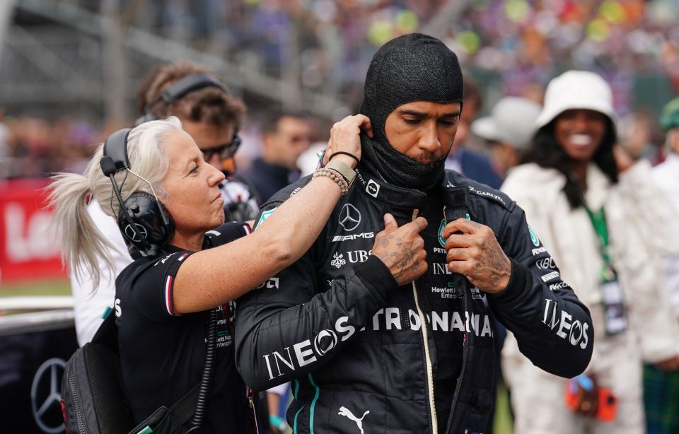 Angela Cullen helping Lewis Hamilton with his balaclava.