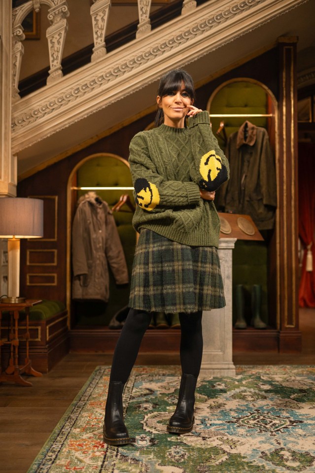 Claudia Winkleman in a green sweater and plaid skirt on the set of The Traitors.