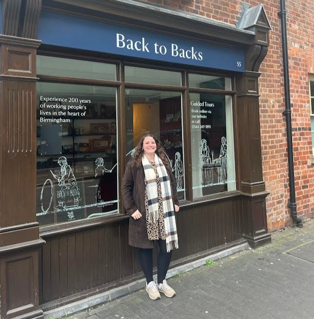 Woman standing in front of Back to Backs museum in Birmingham.