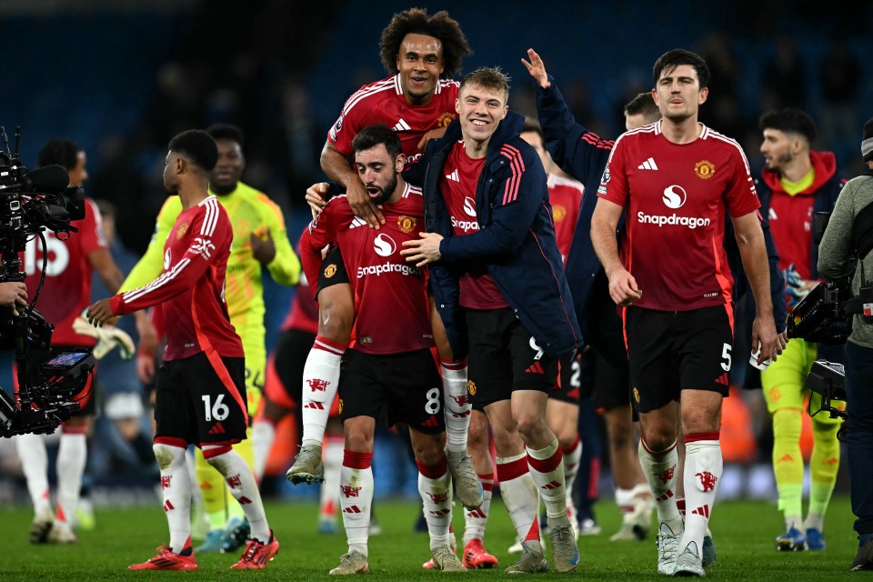 Manchester United soccer players celebrating after a match.