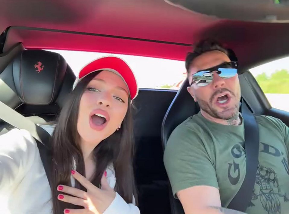 Couple in a car, smiling and talking.