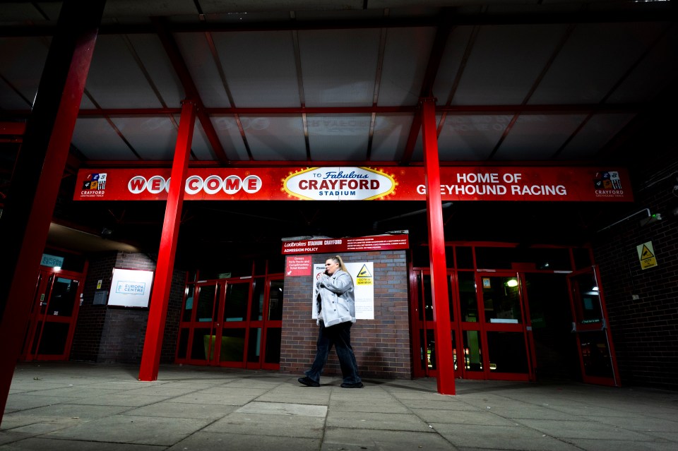 A woman leaves Crayford Greyhound Stadium after its final night of racing.