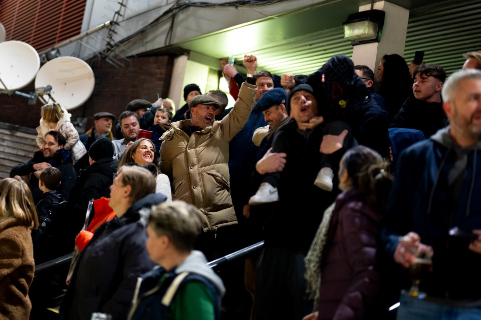 Spectators celebrating at the final night of greyhound racing.